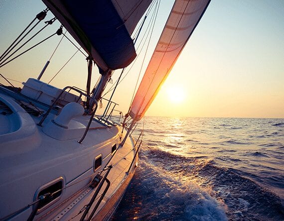 sail boat on the water during sunset